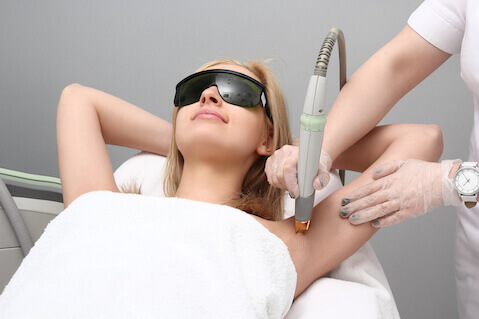 Woman having laser hair removal treatment